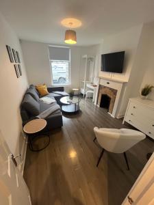 a living room with a couch and a fireplace at Corner Stone House - Apartment 2 in Great Yarmouth