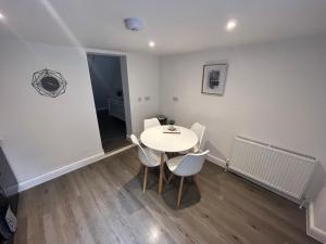 a small dining room with a table and chairs at Corner Stone House - Apartment 2 in Great Yarmouth