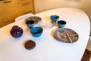 a table with blue bowls and a clock on it at Artistic Spacious Studio Apartment next to metro Monastiraki in Athens