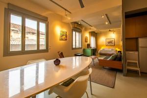 a kitchen and living room with a table and chairs at Artistic Spacious Studio Apartment next to metro Monastiraki in Athens