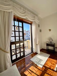 a living room with a large glass door with a window at Spray B&B Sitio in Nazare, European style in Nazaré