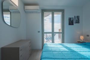 a bedroom with a bed and a mirror and a window at Donatello in Parzanica