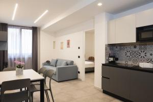a kitchen and living room with a table and a couch at Amiata Suite in Abbadia San Salvatore