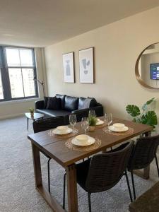 a living room with a wooden table and chairs at Beautiful 1 Bedroom Apartment at Pentagon City in Arlington