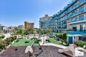 an apartment with a playground in front of a building at Apartamento Borumbot 26 - Grupo Turis in Calpe