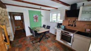 a kitchen with a table and chairs in a room at Ferienhaus Marx in Sebnitz