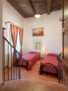 a bedroom with two beds and a window at Castello di Pupaggi in Sellano