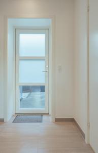 an empty room with a door with a window at New 2 BR Apt - Ocean and Mountain View in Tórshavn