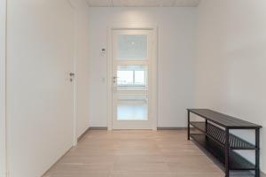 a hallway with a door and a wooden floor at New 2 BR Apt - Ocean and Mountain View in Tórshavn