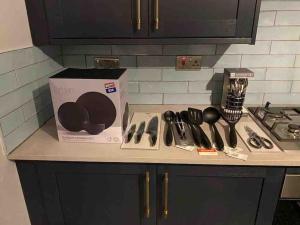 a box of utensils sitting on a kitchen counter at NEW 3-Bedroom Newcastle House in Lemington
