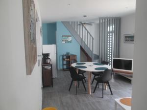 a kitchen and dining room with a table and chairs at TY PLAGE in Saint-Cast-le-Guildo