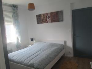a bedroom with a bed and a picture on the wall at TY PLAGE in Saint-Cast-le-Guildo