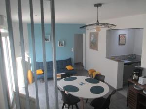 a kitchen and living room with a table and chairs at TY PLAGE in Saint-Cast-le-Guildo +6 photos