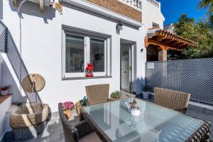 a patio with a glass table and chairs at Loft A'ca La Puri en Melegís in Melegis