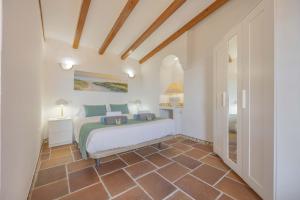 a bedroom with a bed in a room at Villa Plomer Serra in Playa de Muro