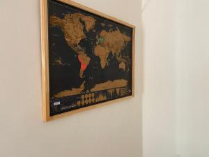 a map of the world hanging on a wall at Technologic Apart in San Miguel de Tucumán