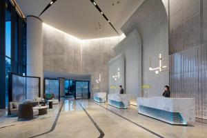 a lobby with couches and tables in a building at Crowne Plaza Chaozhou Riverside, an IHG Hotel in Chaozhou