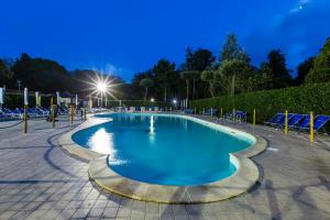 a swimming pool in a park at night at Campeggio Europa in Torre del Lago Puccini