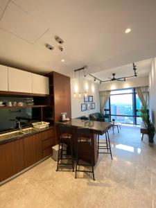 a kitchen with a table and chairs in a room at Anggun Residence Walking distance 5-10mins to Sogo Chow Kit Monorail and LRT station by Juststay in Kuala Lumpur