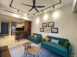 a living room with a couch and a table at Anggun Residence Walking distance 5-10mins to Sogo Chow Kit Monorail and LRT station by Juststay in Kuala Lumpur