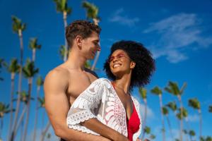 a man and a woman standing on the beach at Paradisus Grand Cana, All Suites - Punta Cana - in Punta Cana