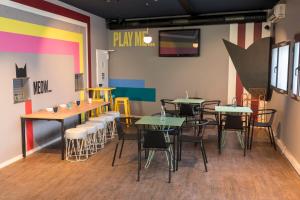 a restaurant with tables and chairs in a room at CATS Porto Hostel in Porto