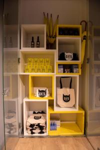 a yellow shelf with items on it in a room at CATS Porto Hostel in Porto