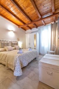 a bedroom with a large bed and a wooden ceiling at Il Chioschetto in Francavilla Fontana