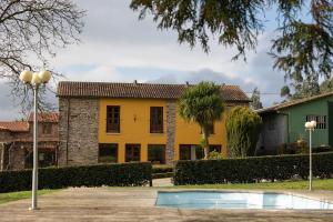 a yellow house with a palm tree in front of it at Casa Curiscada in Burres