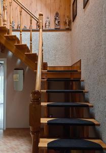 a wooden staircase with blue seats in a room at Słoneczny dom in Michałkowa