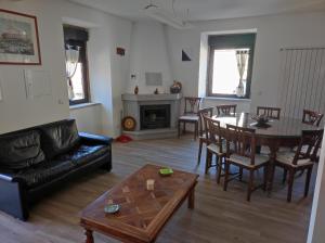 a living room with a couch and a table and chairs at Casa Cruz Trinta in Trinta