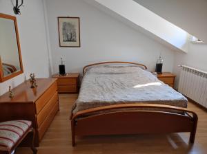 a bedroom with a bed and a dresser at Casa Cruz 