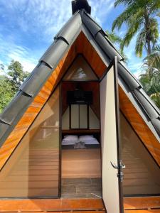a tent with a bed inside of it at Sloth Bungalows Manzanillo in Manzanillo
