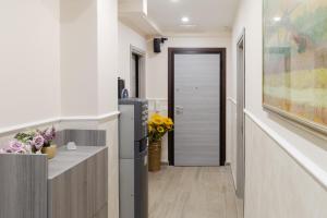a hallway with a door leading into a room with flowers at Affittacamere Alessia in Sanremo