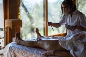 a woman is getting a mans feet at Agriturismo La Cerra in Tivoli