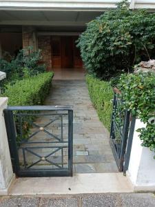 a gate in front of a house with a walkway at Cozy studio Maria in Paleo Faliro in Athens