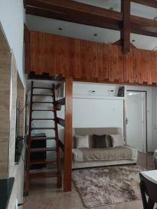 a loft bed in a room with a ladder at Cosy house in Alger