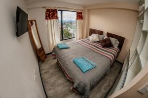 a small bedroom with a bed and a window at Céntrico, Cómodo y Cálido, Dto con Hermosa Vista in Ushuaia