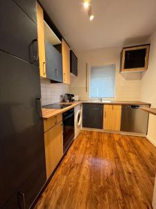 a kitchen with wooden floors and stainless steel appliances at Charmante Ferienwohnung Limburg in Limburg an der Lahn