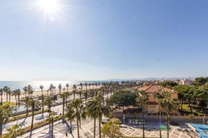 a view of a beach with palm trees and the ocean at Acacias Vista Mar Arysal in Salou