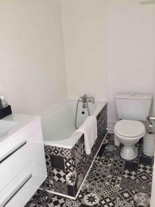 a bathroom with a toilet and a tub and a sink at Studio Anna centre historique Bordeaux St Pierre in Bordeaux