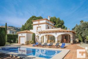 a villa with a swimming pool in front of a house at Villa Angeles - Grupo Turis in Calpe