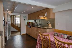 a kitchen with a table with a red table cloth on it at Cosy Family House in Alt Sankt Johann