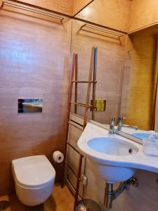 a bathroom with a white sink and a toilet at Casa na Fraga in Aldeia das Dez