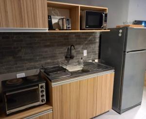 a kitchen with a refrigerator and a stove top oven at Temporarios Santiago in Santiago del Estero