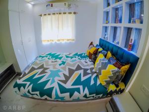 a bedroom with a blue bed and a blue couch at Moroccan Suite Calangute Beach Vibe in Calangute
