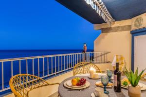 a table with fruit and candles on a balcony with the ocean at tuGuest Velilla Apartment in Almuñécar