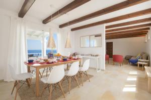 a kitchen and dining room with a table and chairs at Villa SAlgar by Villa Plus in Felanitx