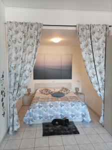 a dog laying on a bed in a bedroom at Residenza La Lanterna in Genoa