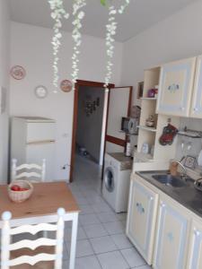 a small kitchen with a sink and a refrigerator at Residenza La Lanterna in Genova